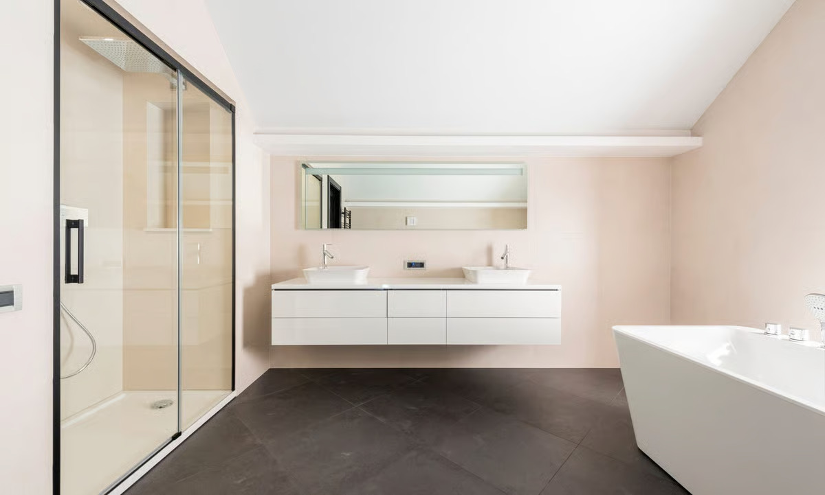 Modern bathroom with freestanding tub, walk-in glass shower, and floating double vanity